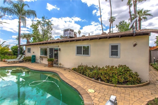 2605 La Praix St, Highland, CA 92346 - back of property with stucco siding, a patio area, an outdoor pool, and cooling unit