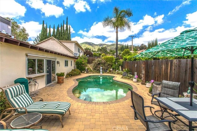2605 La Praix St, Highland, CA 92346 - view of pool with a patio, a fenced backyard, and a mountain view