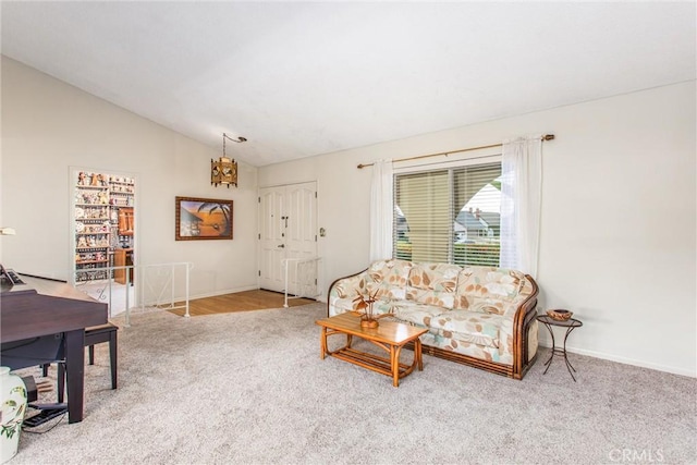 2605 La Praix St, Highland, CA 92346 - living area featuring carpet flooring, lofted ceiling, and baseboards