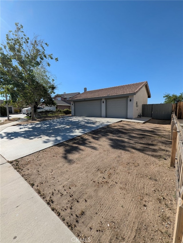 10736 Dove Ct, Adelanto, CA 92301 - single story home featuring a garage, fence, and stucco siding