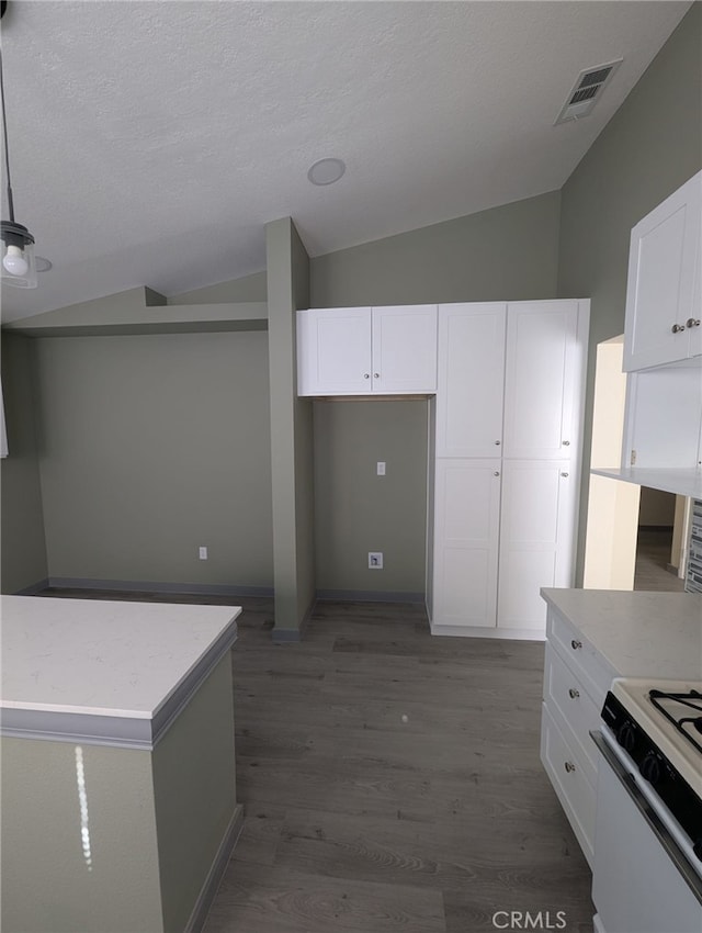 10736 Dove Ct, Adelanto, CA 92301 - kitchen featuring vaulted ceiling, white cabinetry, wood finished floors, light countertops, and white gas range