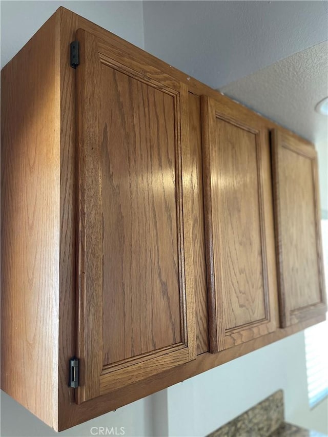 13429 Rancherias Rd, Apple Valley, CA 92308 - kitchen view of brown cabinets and a textured ceiling