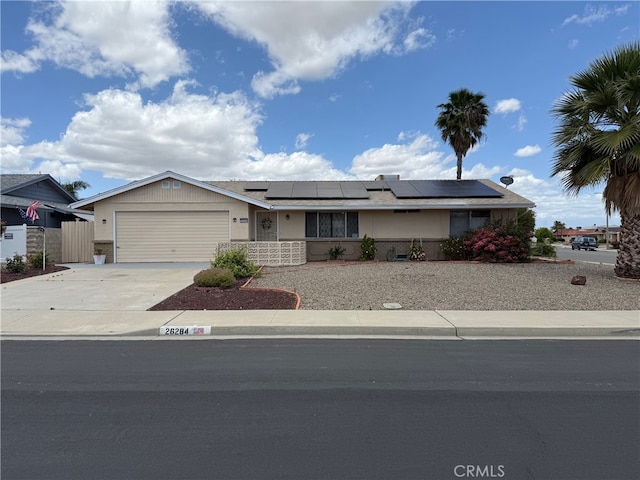 26284 Fairlane Dr, Menifee, CA 92586 - ranch-style home with concrete driveway, an attached garage, and solar panels