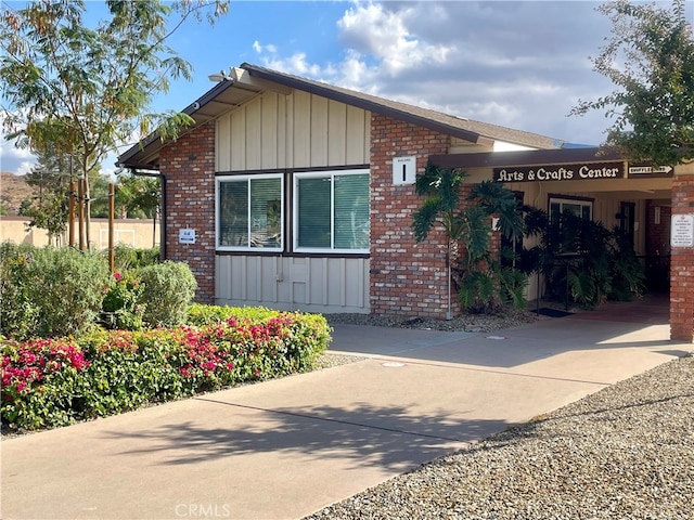 26284 Fairlane Dr, Menifee, CA 92586 - view of side of home with board and batten siding and brick siding