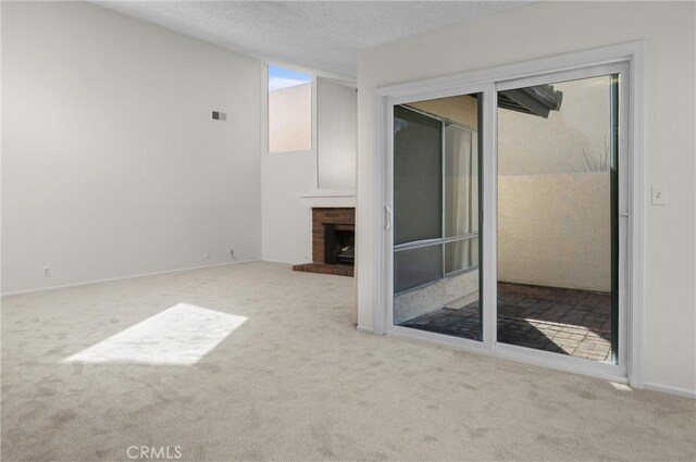 46 Los Palos Dr, San Luis Obispo, CA 93401 - unfurnished living room with carpet flooring, a brick fireplace, and baseboards