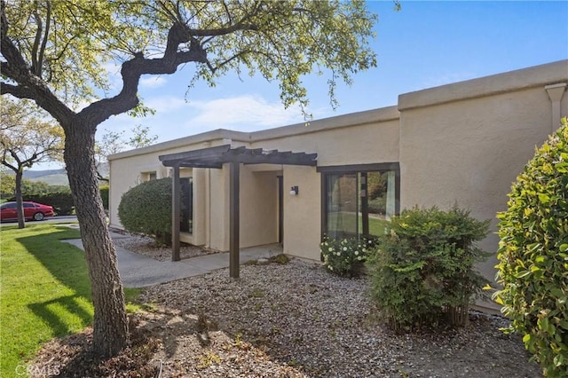 46 Los Palos Dr, San Luis Obispo, CA 93401 - back of property featuring stucco siding, a pergola, and a lawn