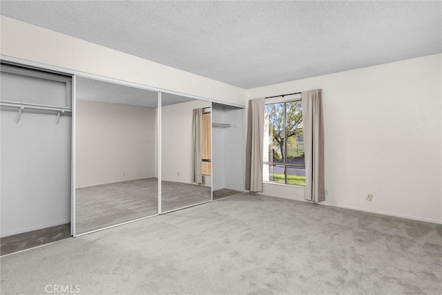 46 Los Palos Dr, San Luis Obispo, CA 93401 - unfurnished bedroom featuring carpet, a textured ceiling, baseboards, and a closet