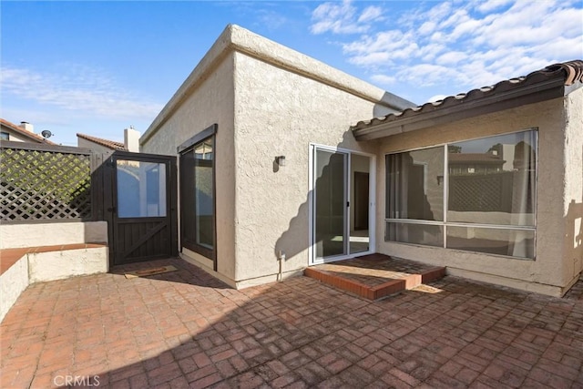 46 Los Palos Dr, San Luis Obispo, CA 93401 - rear view of property with a gate, a patio, stucco siding, and fence