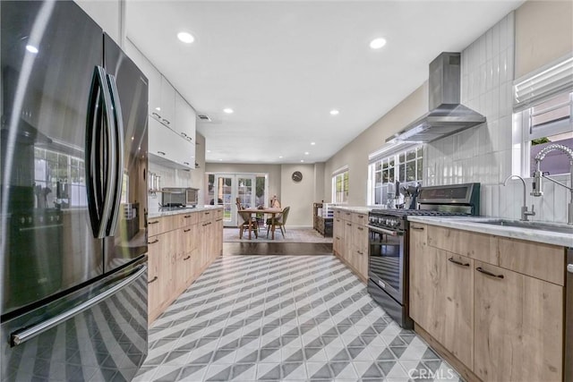 1850 W 186th St, Torrance, CA 90504 - kitchen featuring appliances with stainless steel finishes, wall chimney range hood, a sink, light brown cabinetry, and recessed lighting