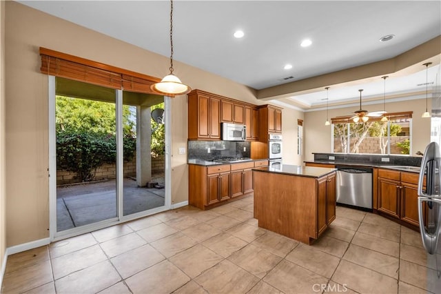 80465 Paseo De Tiempo, Indio, CA 92201 - kitchen featuring appliances with stainless steel finishes, brown cabinets, dark countertops, decorative backsplash, and recessed lighting