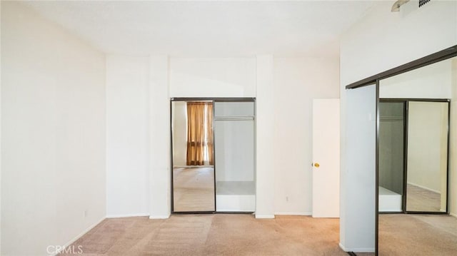 unfurnished bedroom featuring carpet and baseboards