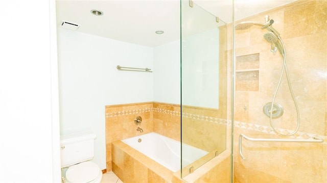 bathroom with a stall shower, a garden tub, and toilet