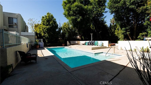 view of pool with a patio area and fence