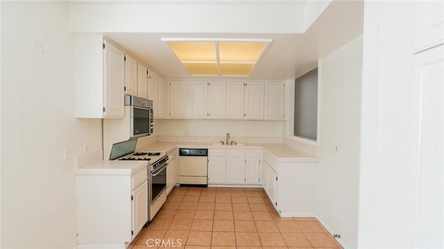kitchen with dishwasher, gas range, a sink, light tile patterned floors, and light countertops