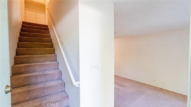 staircase with carpet and baseboards