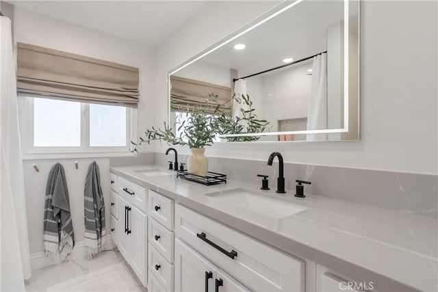 2090 Tevis Ave, Long Beach, CA 90815 - bathroom with marble look tile flooring, double vanity, and recessed lighting