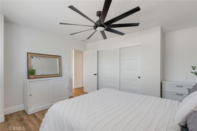 2090 Tevis Ave, Long Beach, CA 90815 - bedroom with light wood-style flooring, baseboards, a closet, and ceiling fan