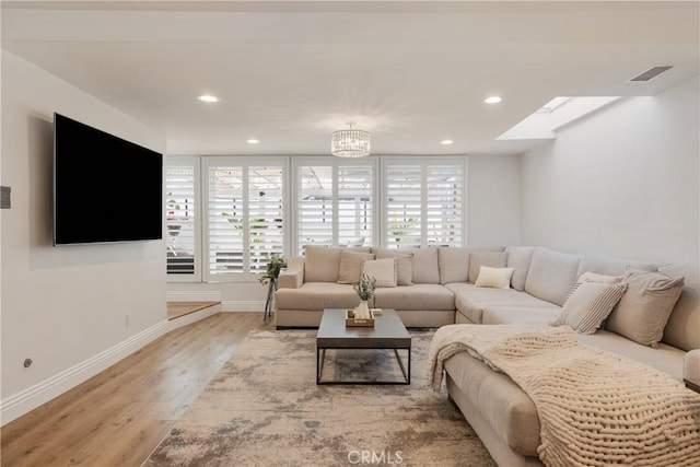 2090 Tevis Ave, Long Beach, CA 90815 - living room featuring light wood-type flooring, baseboards, recessed lighting, and a chandelier
