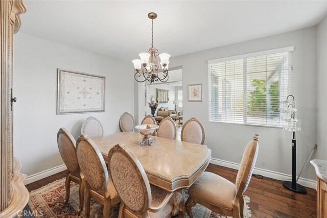 29316 Las Brisas Rd, Valencia, CA 91354 - dining room featuring a chandelier, dark wood-type flooring, and baseboards