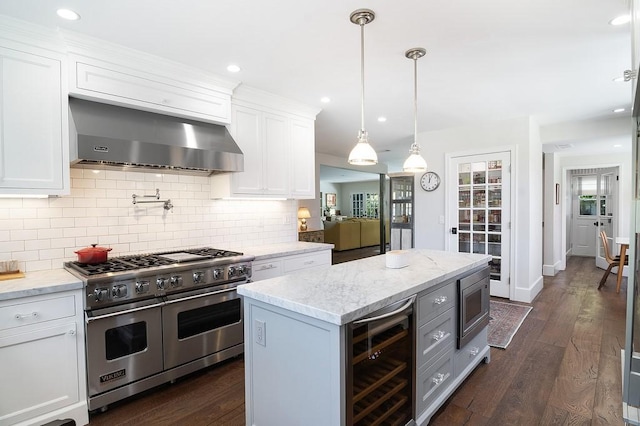 4001 Coldwater Canyon Ave, Studio City, CA 91604 - kitchen featuring stainless steel appliances, wall chimney exhaust hood, beverage cooler, white cabinetry, and tasteful backsplash