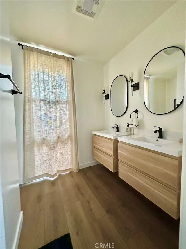7140 N Muscatel Ave, San Gabriel, CA 91775 - full bathroom featuring vanity, wood finished floors, and baseboards