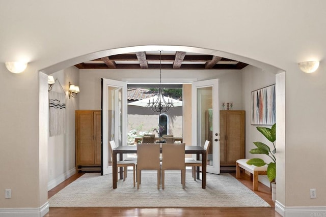 1455 Independence Way, Vista, CA 92084 - dining room with wood finished floors, arched walkways, coffered ceiling, a chandelier, and beamed ceiling