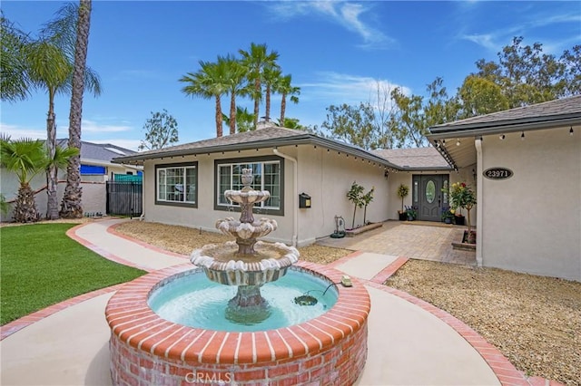 rear view of property featuring a patio area and stucco siding