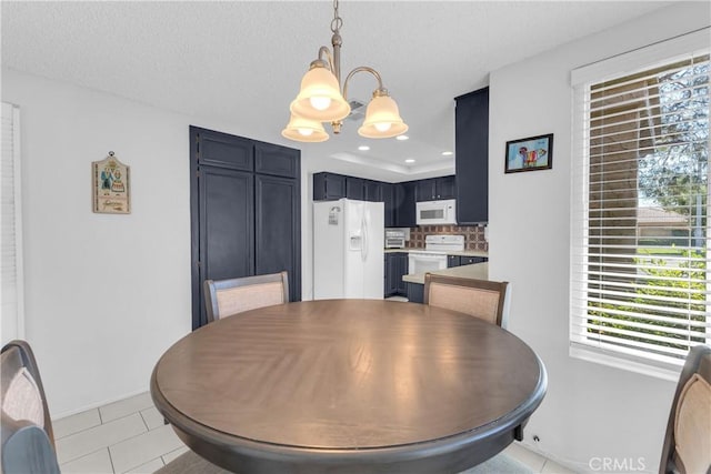 dining area with plenty of natural light, a chandelier, light tile patterned floors, baseboards, and recessed lighting