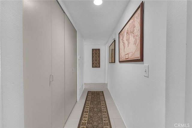 hall featuring light tile patterned flooring