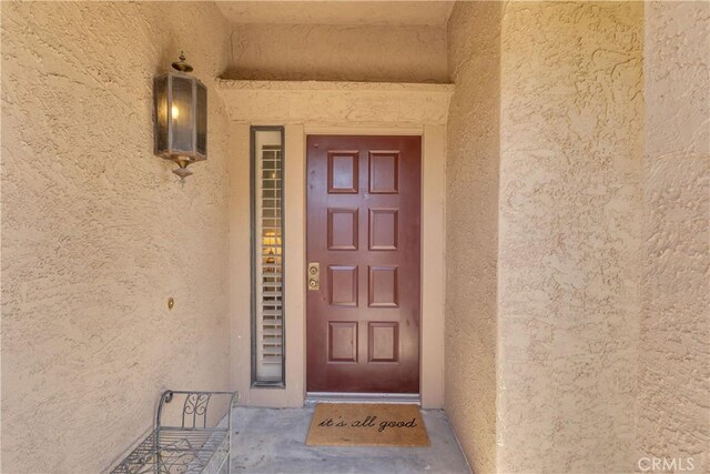 doorway to property with stucco siding
