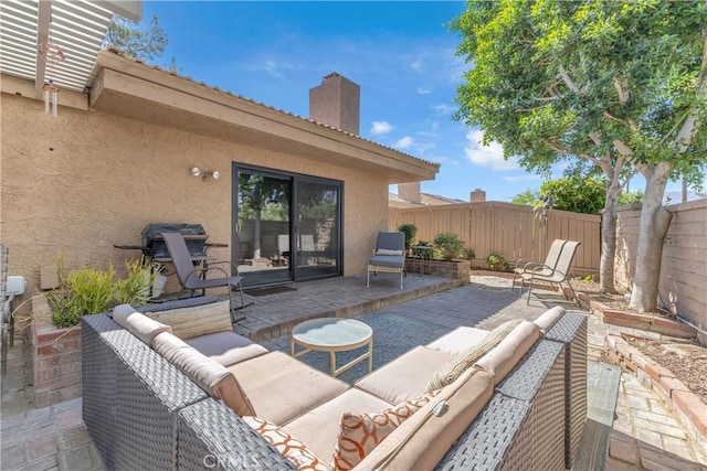 view of patio featuring an outdoor living space and fence