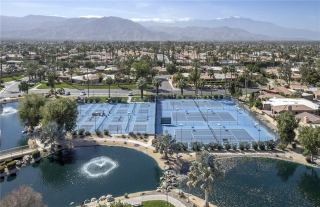 aerial view of property and surrounding area with a water and mountain view and nearby suburban area