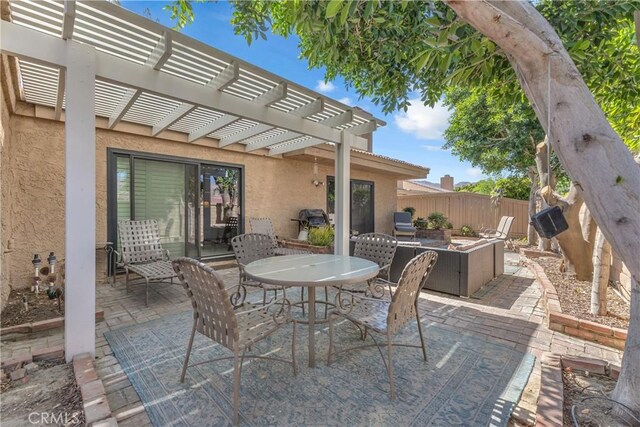 view of patio featuring fence, a pergola, outdoor dining space, and area for grilling