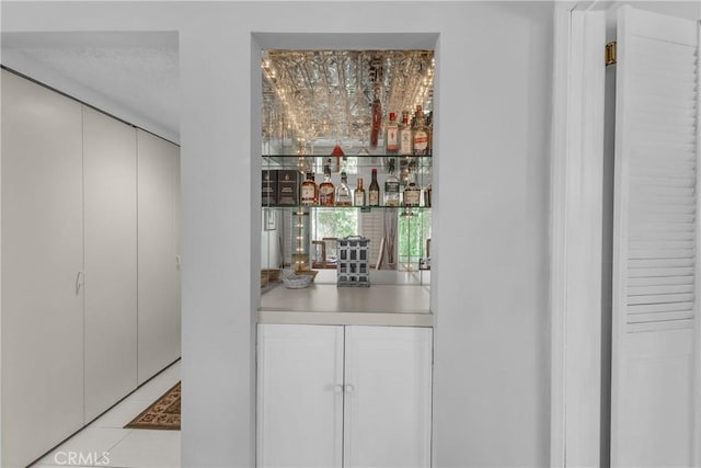 bar area featuring light tile patterned floors