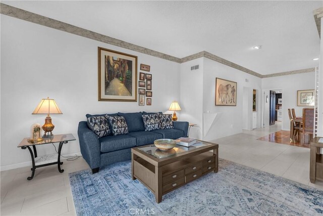 living area with tile patterned floors and baseboards
