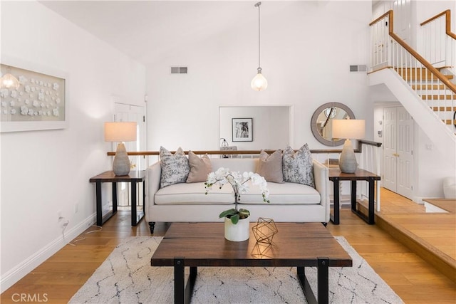 23721 Sarda Rd, Valencia, CA 91355 - living area with stairs, light wood-style flooring, and high vaulted ceiling