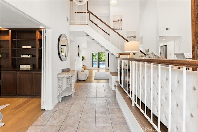 23721 Sarda Rd, Valencia, CA 91355 - stairway with a high ceiling and wood finished floors