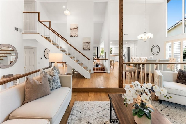 23721 Sarda Rd, Valencia, CA 91355 - living area featuring a high ceiling, a chandelier, stairway, and wood finished floors
