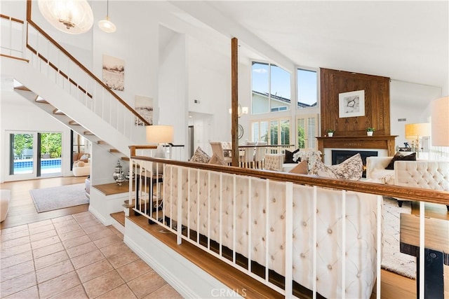 23721 Sarda Rd, Valencia, CA 91355 - stairs with high vaulted ceiling, a large fireplace, and tile patterned floors