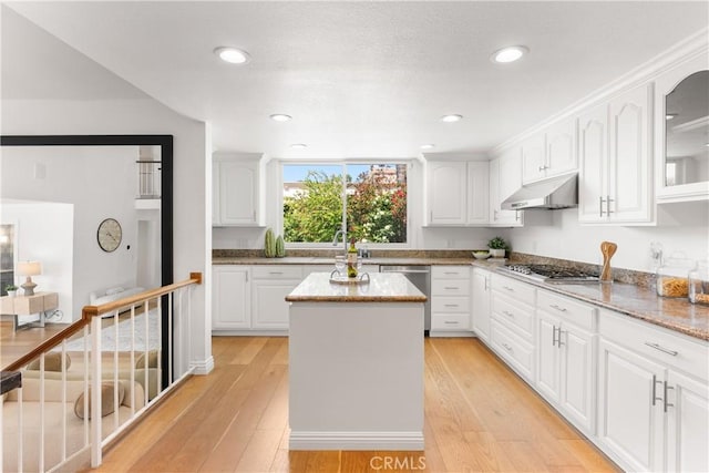 23721 Sarda Rd, Valencia, CA 91355 - kitchen with under cabinet range hood, stainless steel appliances, light wood-style flooring, white cabinets, and recessed lighting