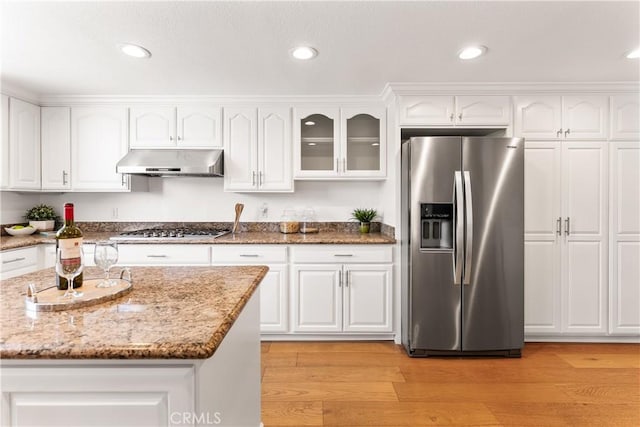 23721 Sarda Rd, Valencia, CA 91355 - kitchen with appliances with stainless steel finishes, under cabinet range hood, white cabinetry, light stone counters, and glass insert cabinets