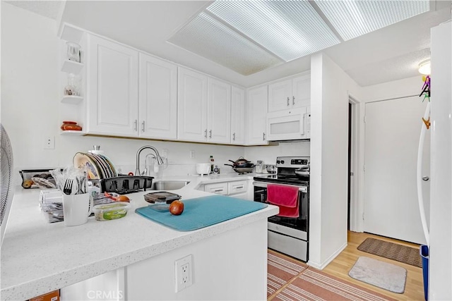 268 Lemon, Irvine, CA 92618 - kitchen with white microwave, stainless steel range with electric stovetop, a sink, and white cabinets