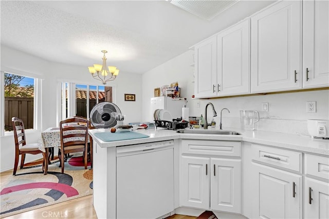 268 Lemon, Irvine, CA 92618 - kitchen featuring white appliances, a sink, a peninsula, a chandelier, and white cabinets