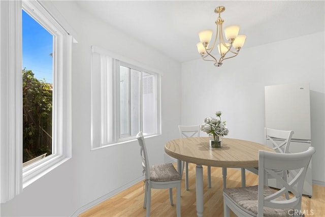 268 Lemon, Irvine, CA 92618 - dining area with a chandelier, light wood finished floors, and baseboards