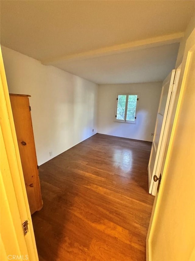 unfurnished room with wood finished floors