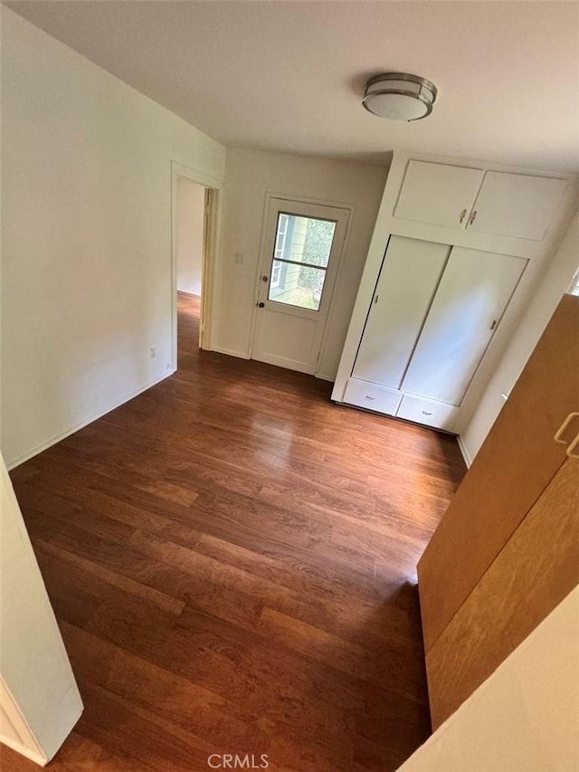 unfurnished bedroom featuring dark wood-style floors