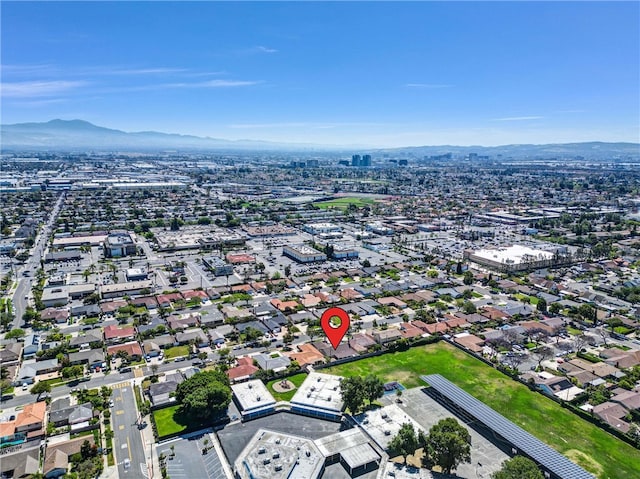 aerial view of property and surrounding area with a mountainous background