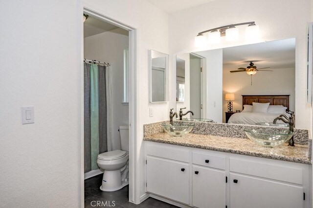 40022 172nd St E, Palmdale, CA 93591 - ensuite bathroom featuring a ceiling fan, double vanity, toilet, and tile patterned flooring