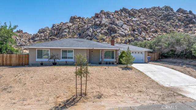 40022 172nd St E, Palmdale, CA 93591 - ranch-style home featuring a garage, concrete driveway, a chimney, and stucco siding