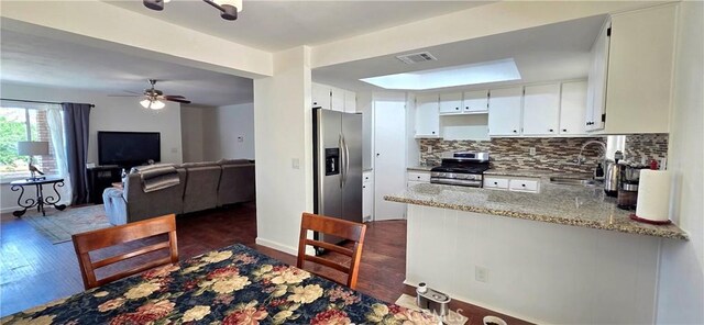 40022 172nd St E, Palmdale, CA 93591 - kitchen featuring stainless steel appliances, a sink, a peninsula, dark wood-style flooring, and backsplash